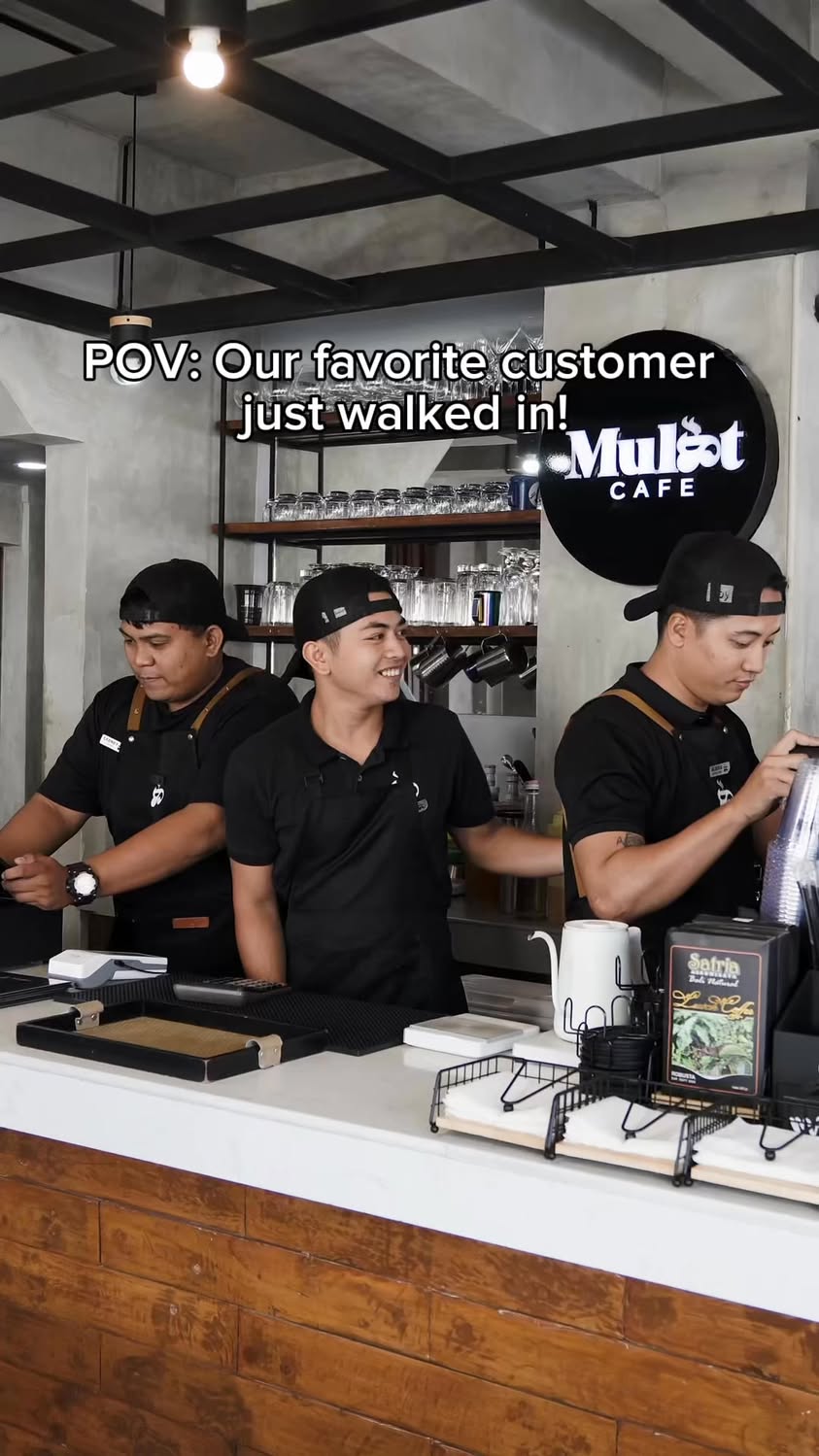 Mulat Cafe interior with baristas at the counter